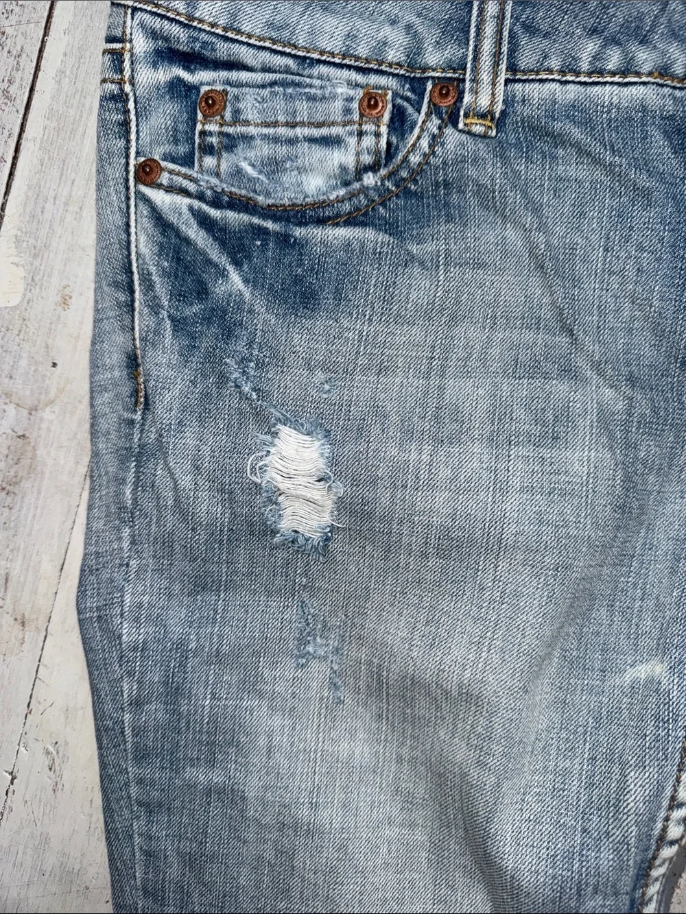 American Eagle Outfitters faded blue distressed jeans